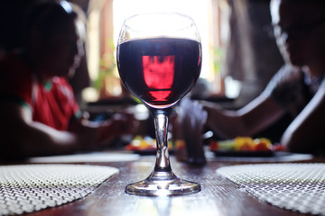 Serving a glass of red wine in a restaurant