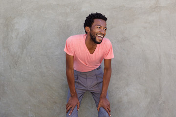 attractive african american man leaning forward laughing