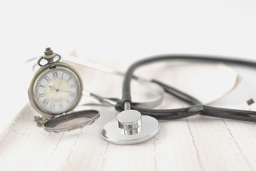 stethoscope with stopwatch on ecg sheet