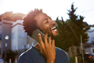 handsome man walking outside talking on mobile phone