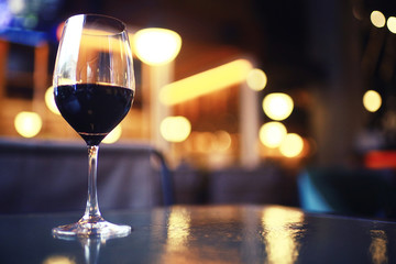 Serving a glass of red wine in a restaurant