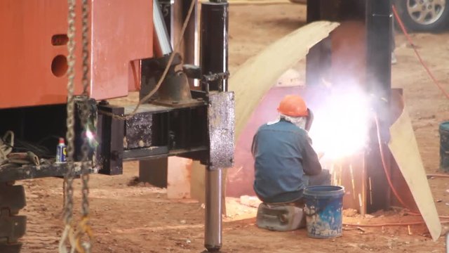 Steel beam welding at a construction site