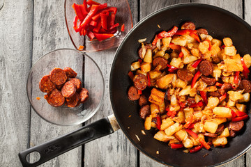 Tortilla de patatas. Cooking spanish omelette with sausage chori