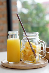 Bottle of Passion fruit juice and lemon served with passion fruit juice ice cubes in the jar.