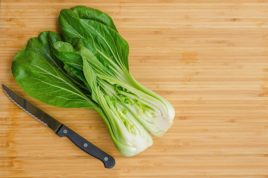 Bok choy with  knife on wooden background. Pak choy is a type of Chinese cabbage(Qing geng cai )and one of the healthiest vegetable and popular superfood.