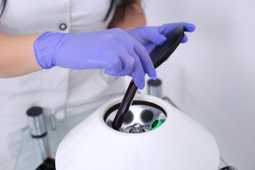 Researcher performs blood centrifuging