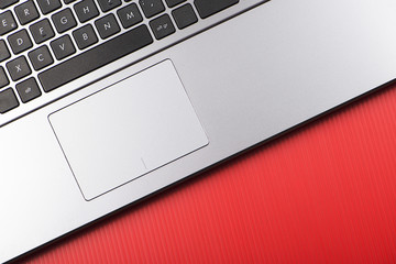 Laptop on red background. Horizontal shoot.