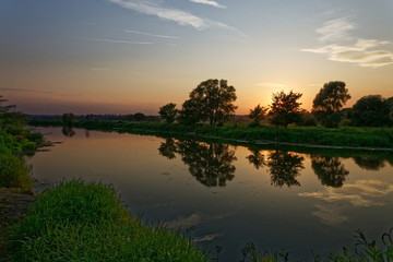 Fototapeta na wymiar A beautiful sunset over the river.