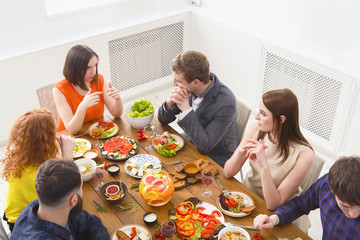 Group of happy people at festive table dinner party