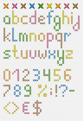 Colorful cross stitch lowercase english alphabet with numbers and symbols. Isolated on white cloth texture