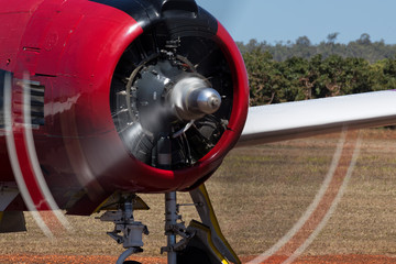 Spinning propeller on old red plane