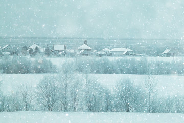 rural landscape with small houses on a snowy day