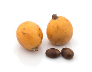 Ripe medlars (Eriobotrya japonica) with bones on a white background. Isolated