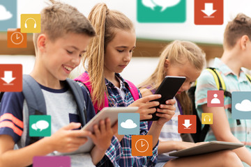 happy elementary school students with tablet pc