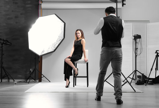 Model posing for professional photographer at studio