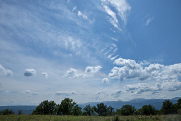 Summer mountains green grass and blue sky with clouds landscape.