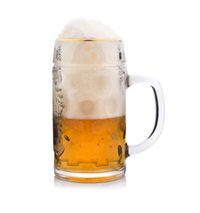 A lot of beer foam in a glass, beer mug on a white background. Isolated