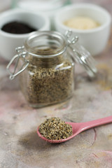 Gomasio- sesame salt. Jar, small bowls with ingredients. 