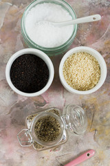 Gomasio- sesame salt. Jar, small bowls with ingredients. 