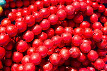 Beaded jewelry. Bright red background from of beads. Hand made souvenirs being sold at the market. Selective Focus.