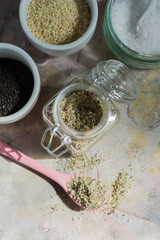 Gomasio- sesame salt. Jar, small bowls with ingredients. 