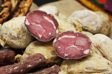 Beef jerky. Dried meat beef jerky on chopping board background. Dry meat, rustic country style. Delicious meat eating.