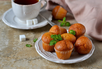 Vanilla cupcakes with banana for breakfast on a concrete background