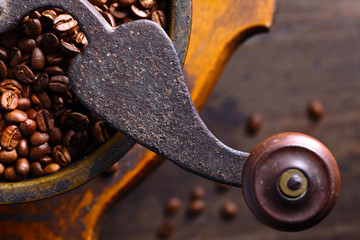  Roasted coffee beans in old coffee grinder.