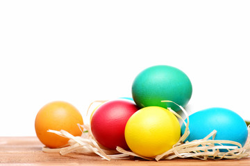 painted easter colorful eggs with straw nest isolated on white