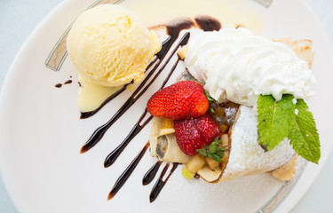 Homemade crepes with ice cream and strawberry