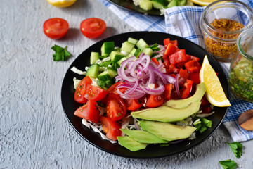 Vegetable salad with avocado and mustard sauce on a concrete, gray background