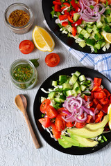 Vegetable salad with avocado and mustard sauce on a concrete, gray background