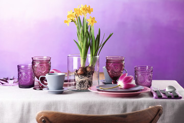 Beautiful table setting on color background