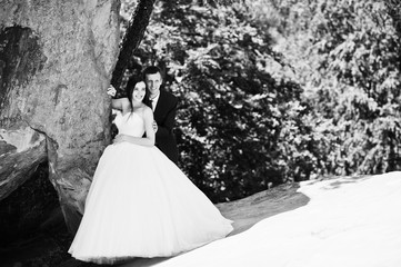 Lovely wedding couple at amazing landscapes with rock Dovbush, Carpathian mountains at Ukraine.