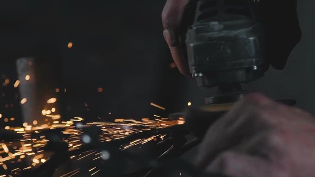 Decorative metalworking: the creation of an openwork decorative metal element. The power tool is in operation. The process of creating a decorative metal product: forged openwork metal.