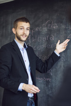 Businessman giving presentation while standing in office