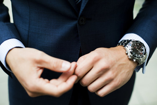 Close up of elegant man wearing full suit and wristwatch