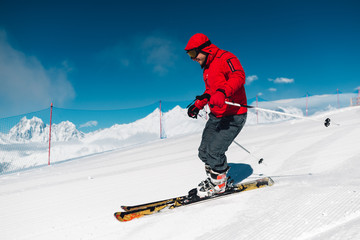 man with special ski equipment is riding very fast in the mountain hill