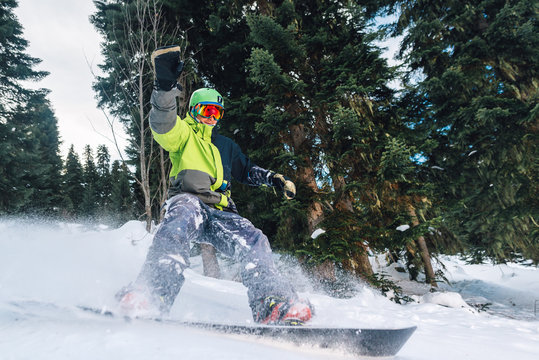 snowboarder with special equipment is riding and slow down in the mountain forest