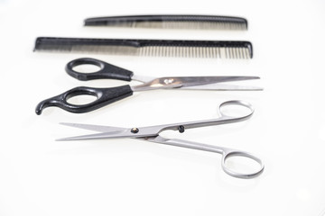 Hair cutting shears and comb isolated on white