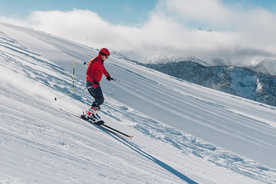 man with special ski equipment is riding very fast in the mountain hill