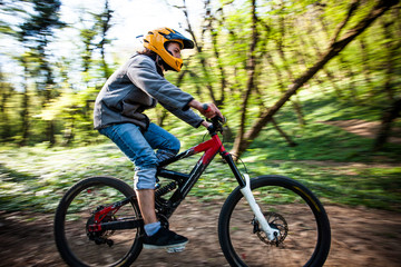 Fototapeta premium man ride mountain bike through forest