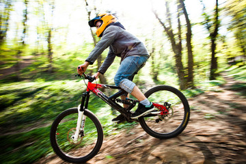 Fototapeta na wymiar man ride mountain bike through forest