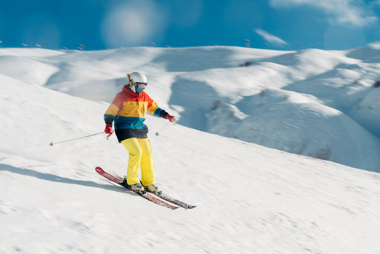 girl with special ski equipment is riding very fast in the mountain hill