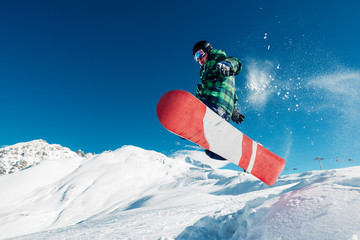 snowboarder is jumping with snowboard from snowhill - obrazy, fototapety, plakaty