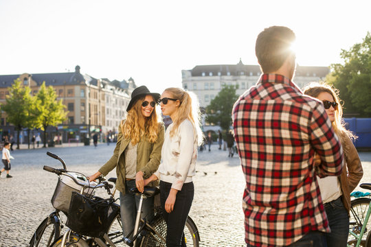 Friends talking on city street