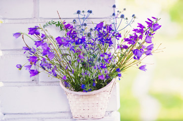 Bunch of wild flowers in a wicker basket 