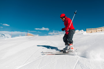 man with special ski equipment is riding very fast in the mountain hill