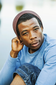 Portrait of confident young man at lakeshore