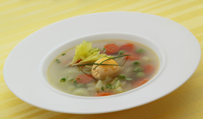 Vegetable spring soup with carrot, peas, celery and egg. 